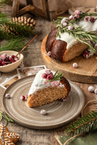 Wallpaper Mural A piece of Christmas gingerbread cake with white sugar glaze decorated with cranberries on a plate, wooden festive rustic decorated background Torontodigital.ca