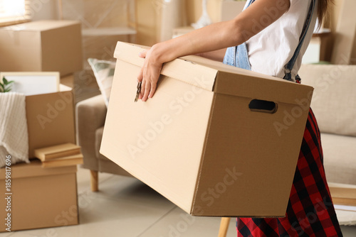 Young woman with cardboard ...