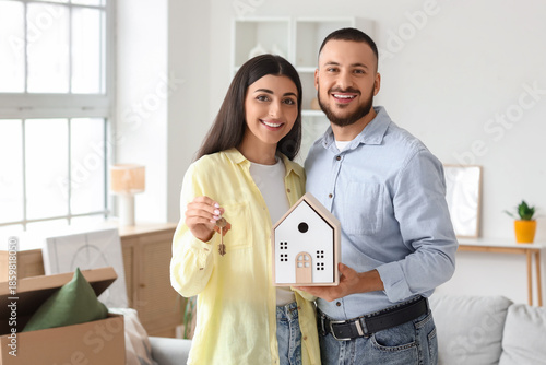 Happy young couple with hou...