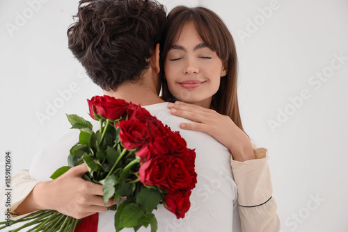 Young woman with red roses ...