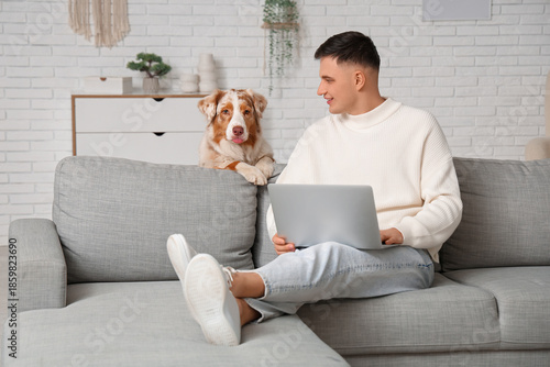 Young man with modern lapto...