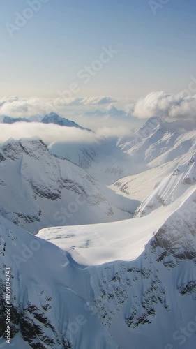 Breathtaking view of the snowy Rocky Mountains and valley on sunny day