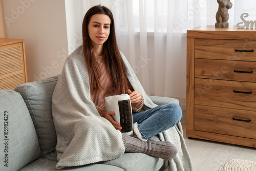 Young woman with warm plaid...