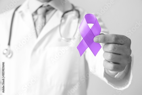 Doctor holding purple aware...