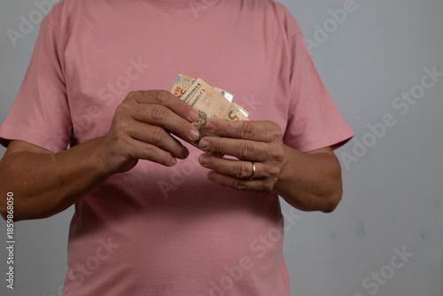 person holding a 50 real note without showing their face