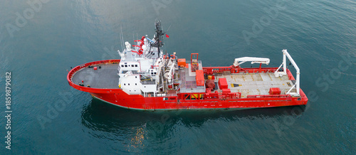 Fotografie Side profile aerial view of a red specialized research vessel in the open sea sh