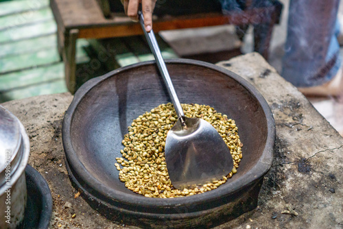 Roasting coffee in the traditional way and using pottery (Indonesian call it kreweng)