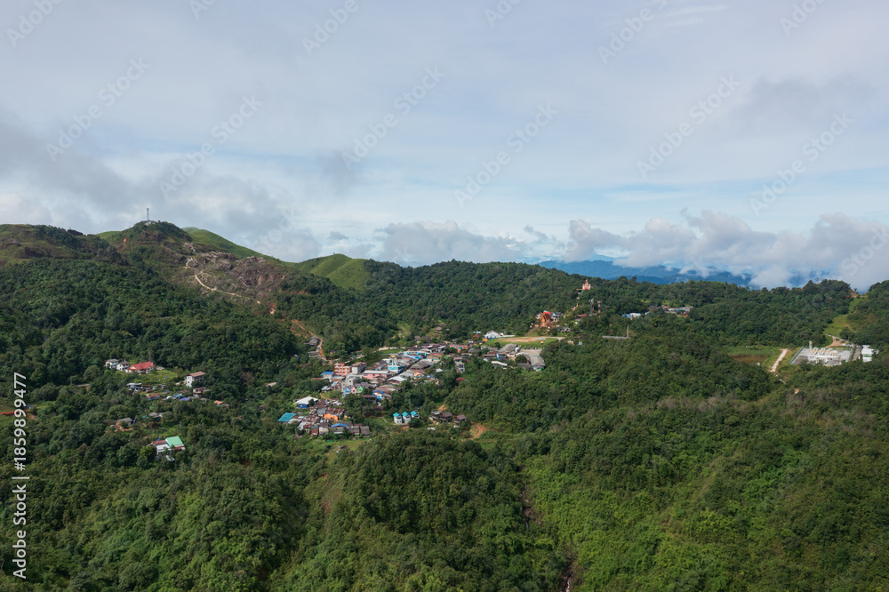 Obraz premium E-Tong Village (or Baan E-Tong) in Kanchanaburi is a charming, misty village near the Thai-Myanmar border. Aerial view from a drone.