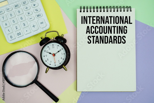 International Accounting Standards text with calculator, alarm clock and magnifying glass