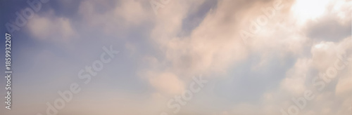 Gentle morning sky with soft beige and blue tones, wispy clouds drifting through hazy sunlight, evoking a quiet, minimal, and calming mood perfect for peaceful reflection and fresh starts

