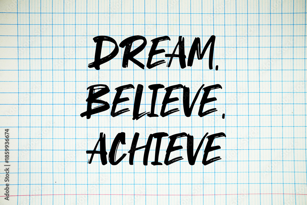 Naklejka premium Dream, Believe, Achieve text written on white notebook sheet with grid
