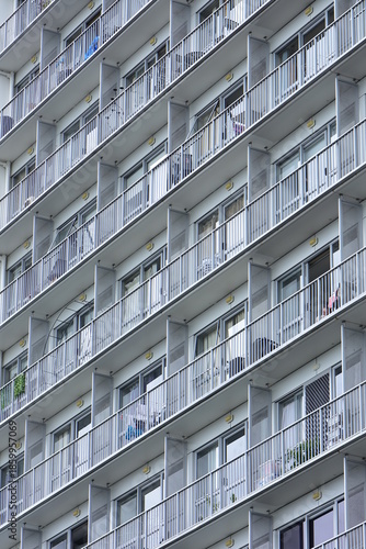 Repeating patterns of identical balconies on exterior wall of apartment building. Location: Auckland New Zealand