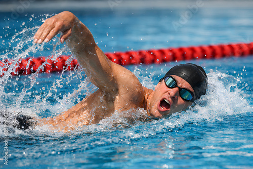 Professional Swimmer Performing Freestyle Stroke in Outdoor Competition Pool