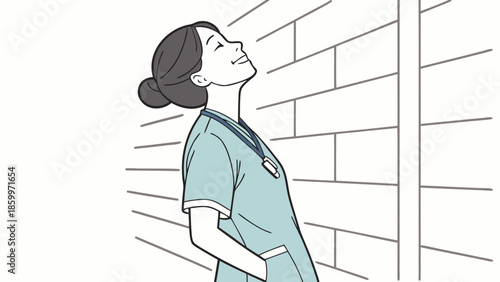 A nurse in scrubs looking up with a smile, leaning against a brick wall.
