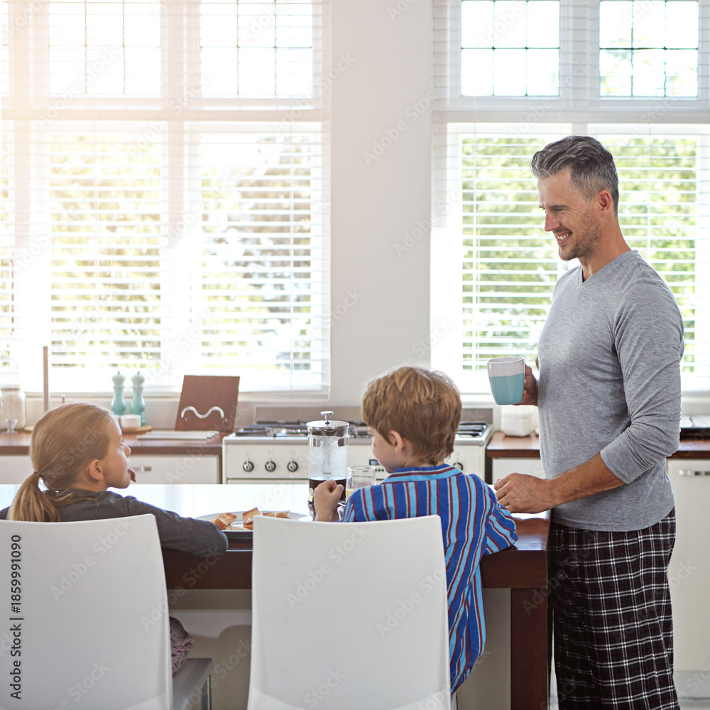 Obraz premium Breakfast, man and children in kitchen with coffee, morning chat and bonding with family. Mature father, drink and talking in home with food, weekend routine and care for kids with nutrition in house