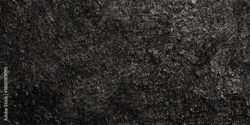 A close up view of dark textured material resembling coarse fabric or a densely packed granular surface