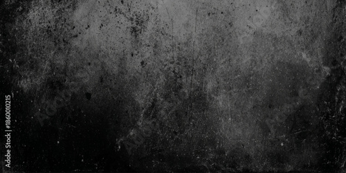 A dark grainy texture dominates the image presenting a mottled surface with subtle variations in tone and light