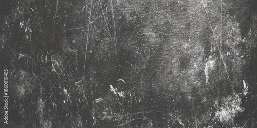 A stark monochromatic image displaying a heavily textured and distressed surface with varied light and dark areas