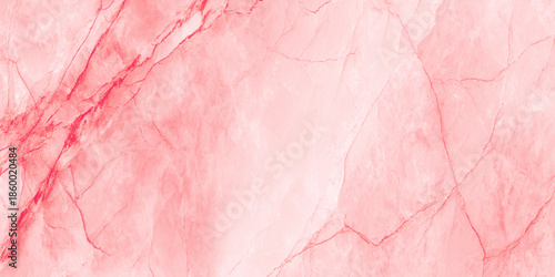 A detailed close up captures the swirling patterns and delicate veins of a vibrant pink marble texture
