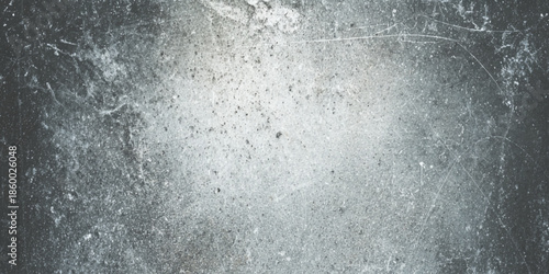 A distressed textured gray surface displaying a weathered and grainy appearance offering a neutral backdrop