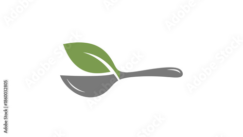 Healthy food concept with a spoon and a green leaf, representing organic eating.