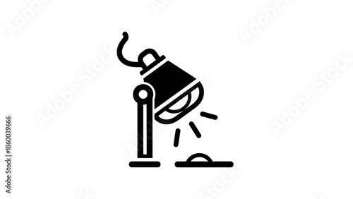 Spotlight illuminating a small object on a surface.