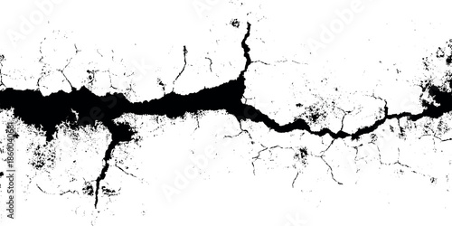 A stark black and white depiction of a fractured surface showcasing jagged cracks and broken texture