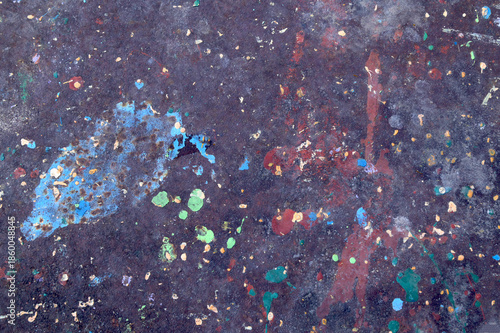 Abstract paint splatter texture on dark surface