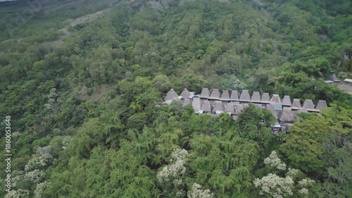 Wallpaper Mural A cinematic drone orbiting shot of traditional thatched houses and megalithic structures in Bena Village, Flores, Indonesia.
 Torontodigital.ca