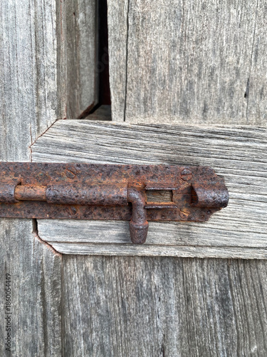 old rusty metal lock on a wooden background