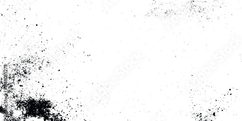 A stark black and white abstract grunge texture featuring scattered speckles and dark blurred patches on a white background