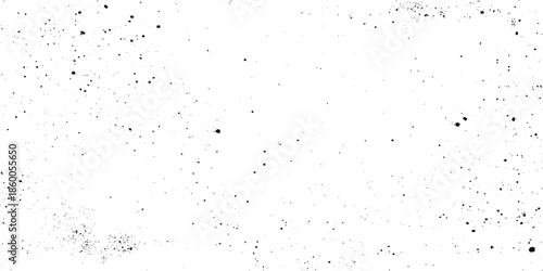 A abstract grunge texture featuring dark specks predominantly white background resembling distressed film or noise.