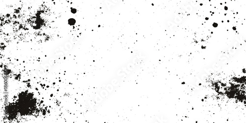 a close up view of a heavily grunge textured surface displaying dark irregular splatters and abstract patterns