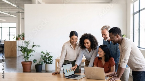 Diverse team collaborating on data analysis in modern office