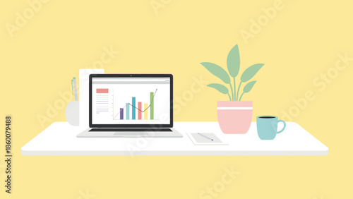 A laptop on a white desk with a graph on the screen, a potted plant, and a coffee cup beside it