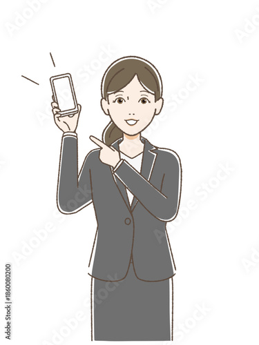 片手でスマホを持ち指をさして話すスーツの女性
