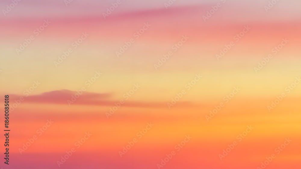 Fototapeta premium Warm abstract sunset sky gradient with soft orange yellow and pink blended clouds