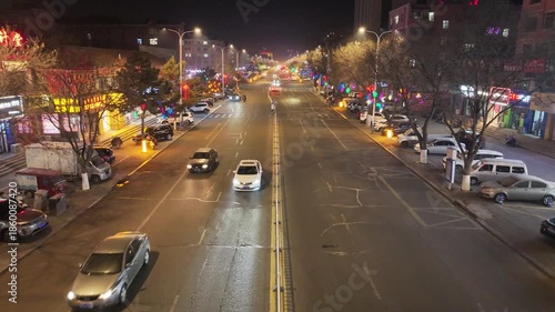 Busy Night City Street with Neon Signs and Traffic