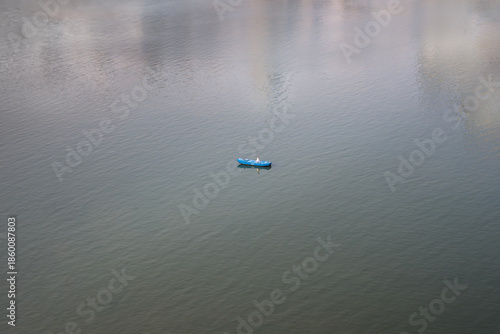 A lone blue boat on the water