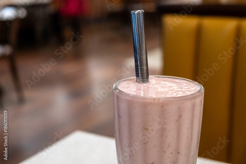 A glass of strawberry milkshake on the table