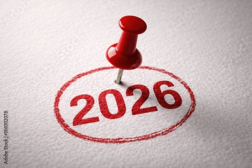 Red push pin marking the year 2026 on white textured paper as symbol of planning and important date