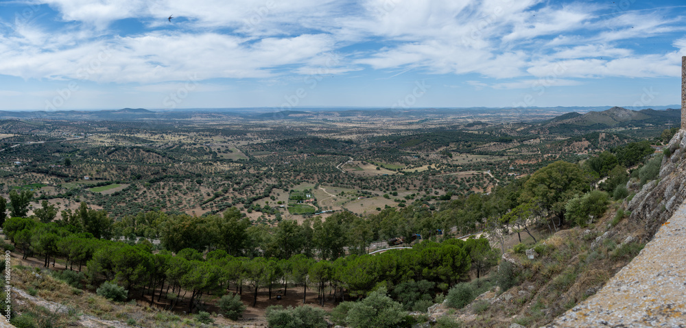 Naklejka premium Panoramic landscape view with rolling hills and trees