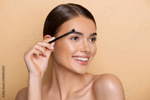 Smiling Woman Applying Makeup to Her Eyebrows - Beauty and Self-Care