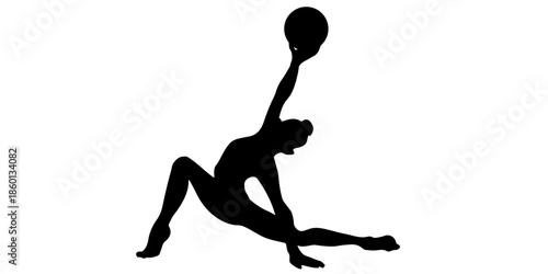 Silhouette of a woman performing a yoga pose with a ball