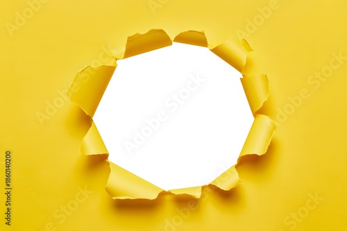 Torn hole in yellow paper with white copy space inside