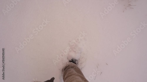 POV of walking through deep snow in Erzurum, Turkey, during active snowfall, boots sinking with each step. Winter adventure highlighting cold weather, survival, and outdoor exploration. For travel.