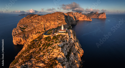 Mallorca, Spain - Aerial panoramic view of the Lighthouse at Cap de Formentor at sunrise with amazing cliffs of the Balearic islands and clouds and blue sky at background