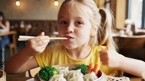 Young girl enjoying meal with chopsticks close up interior shot