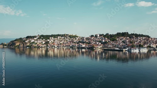 Gorgeous aerial view of Ohrid Lake and the city on the shore, boats near shore