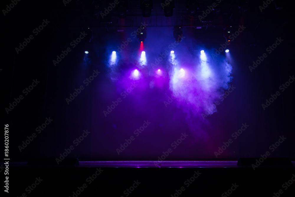 Obraz premium An empty stage of the theater, lit by spotlights and smoke before the performance